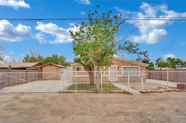 75 N 27th St, Las Vegas, NV 89101 - view of front of property featuring concrete driveway, a fenced front yard, an attached garage, and a gate