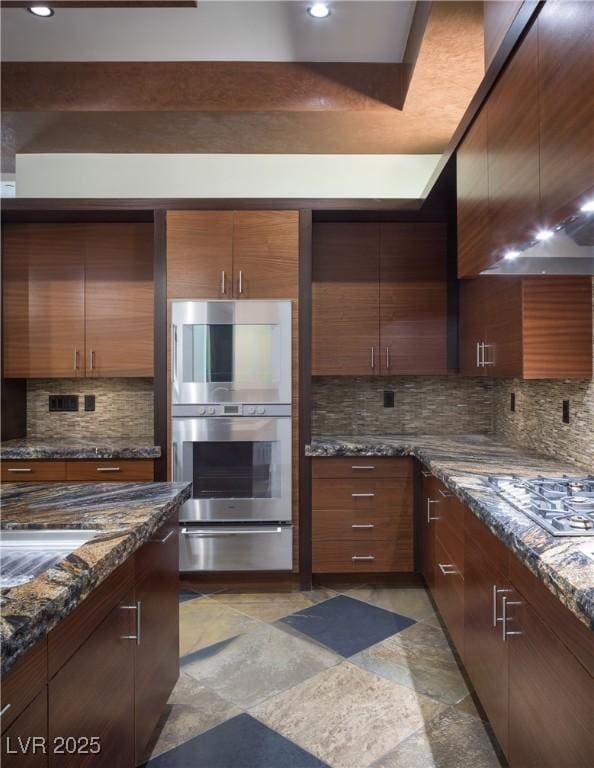 17 Soaring Bird Ct, Las Vegas, NV 89135 - kitchen featuring a warming drawer, appliances with stainless steel finishes, tasteful backsplash, wall chimney range hood, and dark stone counters