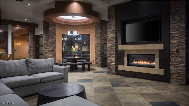 17 Soaring Bird Ct, Las Vegas, NV 89135 - living room featuring stone finish flooring, a glass covered fireplace, and recessed lighting