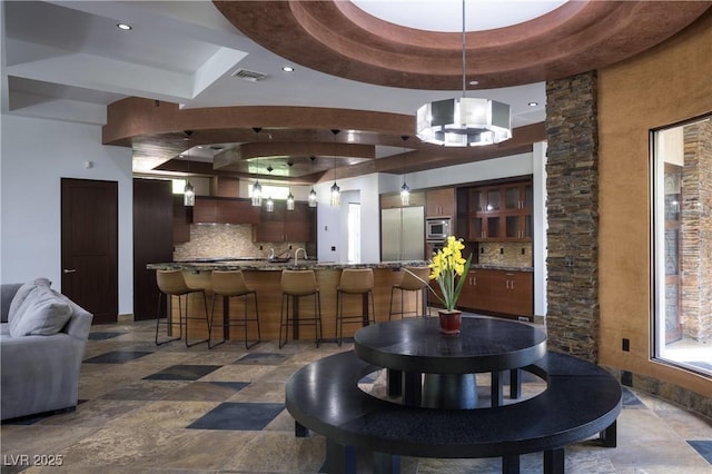 17 Soaring Bird Ct, Las Vegas, NV 89135 - dining area with a tray ceiling, stone tile floors, and recessed lighting