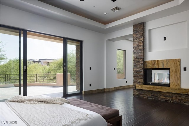 17 Soaring Bird Ct, Las Vegas, NV 89135 - bedroom with wood-type flooring, access to outside, and a stone fireplace