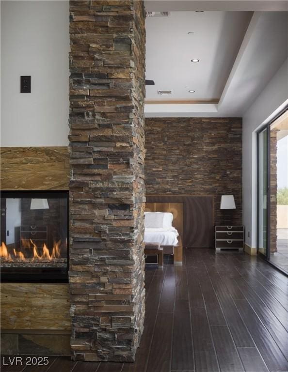 17 Soaring Bird Ct, Las Vegas, NV 89135 - unfurnished bedroom with wood-type flooring, access to outside, and a fireplace