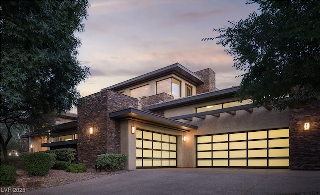 17 Soaring Bird Ct, Las Vegas, NV 89135 - contemporary home with stone siding, driveway, an attached garage, and stucco siding