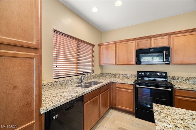 5338 Lignum Ave, Pahrump, NV 89061 - kitchen with black appliances, light stone counters, recessed lighting, and brown cabinetry