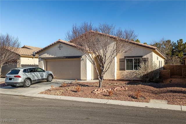 5338 Lignum Ave, Pahrump, NV 89061 - view of front of house with an attached garage, stucco siding, driveway, and a tile roof
