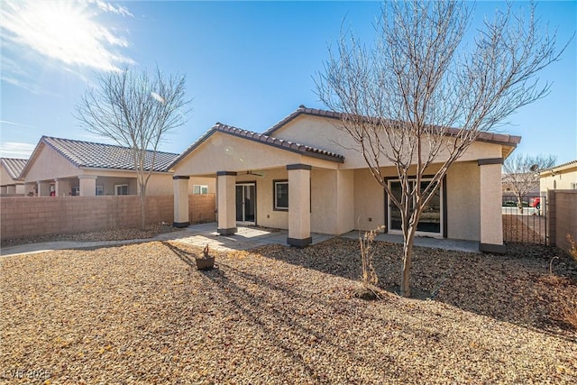 5338 Lignum Ave, Pahrump, NV 89061 - back of house featuring stucco siding, a fenced backyard, a patio area, and a ceiling fan