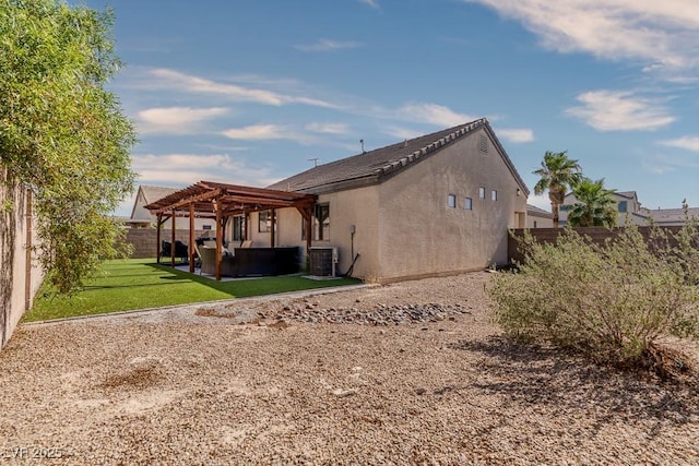 5028 Crying Heart St, North Las Vegas, NV 89031 - back of property featuring a pergola, a fenced backyard, stucco siding, a patio area, and outdoor lounge area