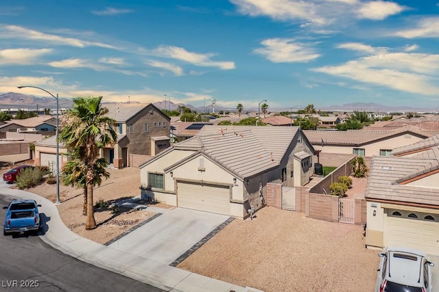 5028 Crying Heart St, North Las Vegas, NV 89031 - view of front facade with a residential view, a gate, stucco siding, concrete driveway, and a garage