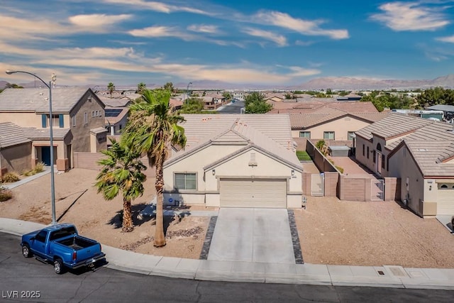 5028 Crying Heart St, North Las Vegas, NV 89031 - view of front facade with a residential view, a gate, an attached garage, and concrete driveway