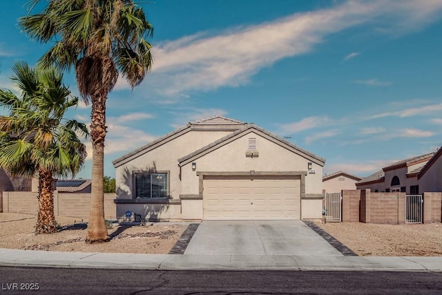 5028 Crying Heart St, North Las Vegas, NV 89031 - ranch-style house with a gate, a garage, concrete driveway, and stucco siding