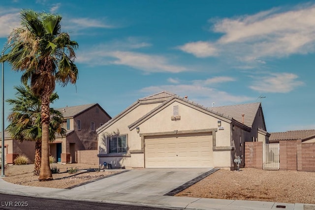 5028 Crying Heart St, North Las Vegas, NV 89031 - view of front of home with a garage, concrete driveway, stucco siding, and a gate