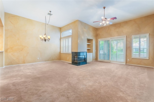 10037 Summer Oak Ln Unit 102, Las Vegas, NV 89134 - unfurnished living room featuring healthy amount of natural light, built in features, a chandelier, and a ceiling fan