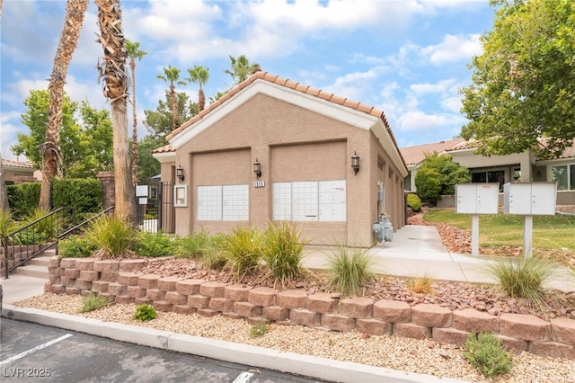 10037 Summer Oak Ln Unit 102, Las Vegas, NV 89134 - view of front of property with a tile roof, stucco siding, and a detached garage