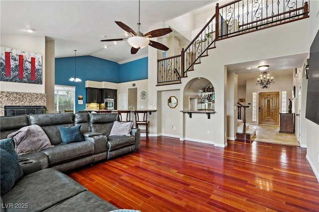 2010 Catalina Marie Ave, Henderson, NV 89074 - living room featuring stairs, a chandelier, high vaulted ceiling, ceiling fan, and wood finished floors