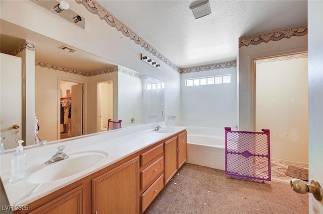 5907 Zawawi Ct, Las Vegas, NV 89110 - bathroom featuring double vanity, a garden tub, and a textured ceiling