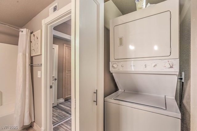 230 E Flamingo Rd Unit 203, Las Vegas, NV 89169 - washroom featuring stacked washer / drying machine and light wood finished floors