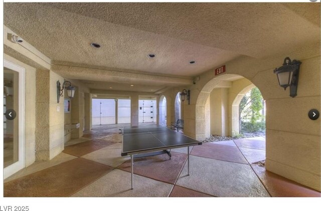 230 E Flamingo Rd Unit 203, Las Vegas, NV 89169 - playroom featuring a textured ceiling and arched walkways