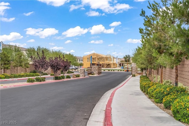 3621 Arcadian Sea St, Las Vegas, NV 89106 - view of asphalt road with sidewalks, curbs, and a gated entry