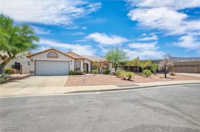 114 Tamarack Dr, Henderson, NV 89002 - mediterranean / spanish home featuring an attached garage, stucco siding, driveway, and a tiled roof