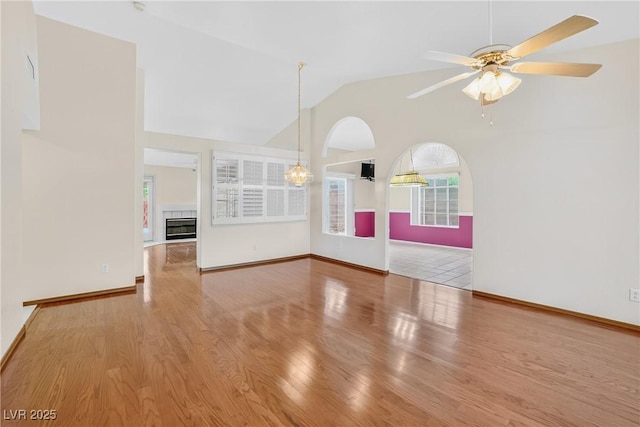 114 Tamarack Dr, Henderson, NV 89002 - unfurnished room with ceiling fan, wood finished floors, a tile fireplace, and high vaulted ceiling