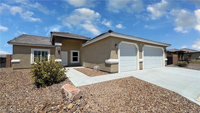 210 Magnolia Blvd, Pahrump, NV 89048 - view of front of property featuring stucco siding, driveway, an attached garage, and a tile roof