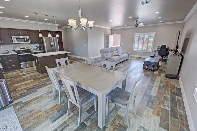 210 Magnolia Blvd, Pahrump, NV 89048 - dining space with crown molding, recessed lighting, wood finished floors, ceiling fan, and a chandelier