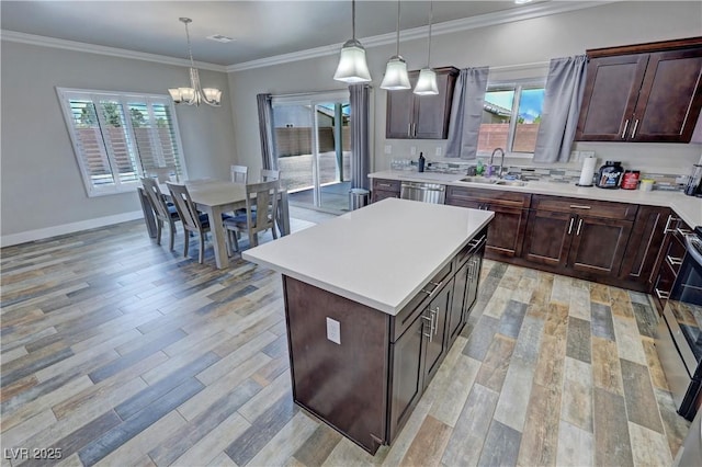 210 Magnolia Blvd, Pahrump, NV 89048 - kitchen featuring a chandelier, light countertops, light wood-type flooring, stainless steel dishwasher, and dark brown cabinets
