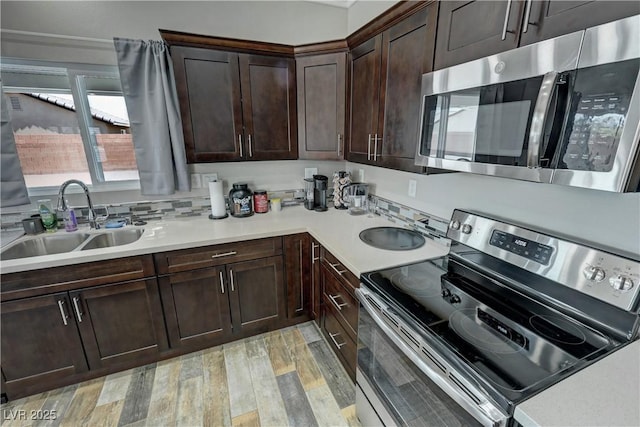 210 Magnolia Blvd, Pahrump, NV 89048 - kitchen featuring appliances with stainless steel finishes, light wood finished floors, light countertops, and dark brown cabinets