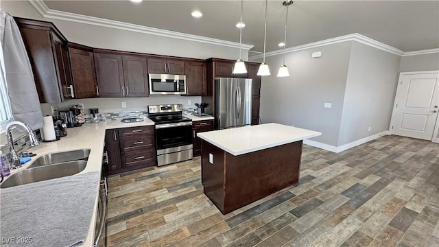 210 Magnolia Blvd, Pahrump, NV 89048 - kitchen with stainless steel appliances, dark brown cabinets, a kitchen island, light countertops, and decorative light fixtures