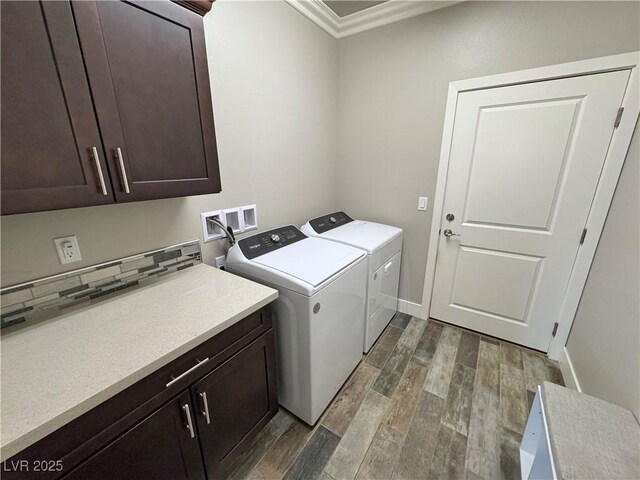 210 Magnolia Blvd, Pahrump, NV 89048 - laundry area with cabinet space, dark wood-style floors, washer and clothes dryer, and crown molding