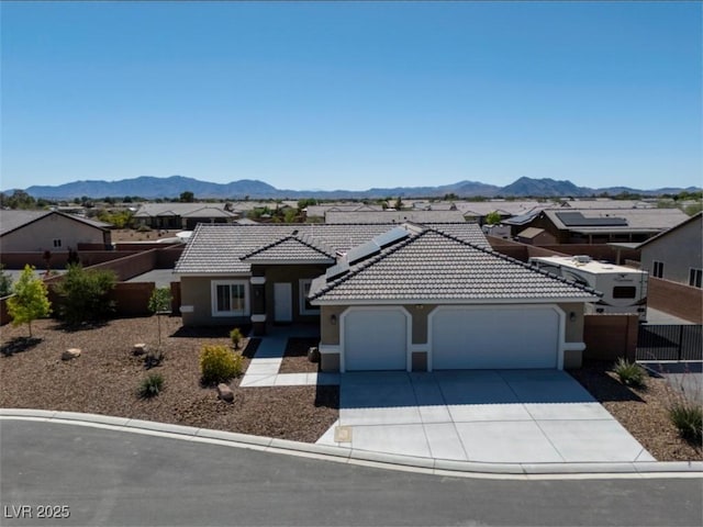 210 Magnolia Blvd, Pahrump, NV 89048 - view of front facade with a garage, stucco siding, concrete driveway, and a mountain view