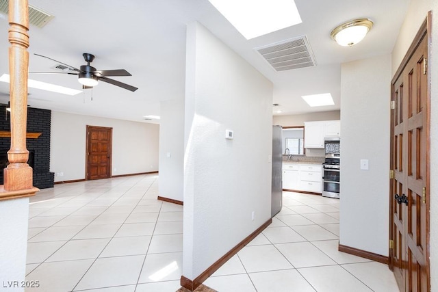 1050 Morgan Ln, Pahrump, NV 89060 - hall with light tile patterned floors and a skylight