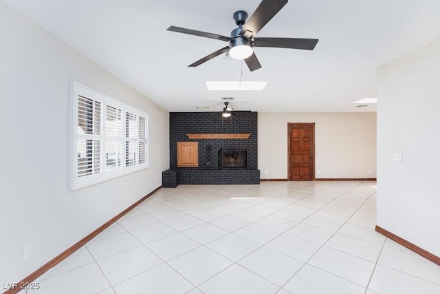 1050 Morgan Ln, Pahrump, NV 89060 - unfurnished living room with ceiling fan, a fireplace, a skylight, and light tile patterned floors