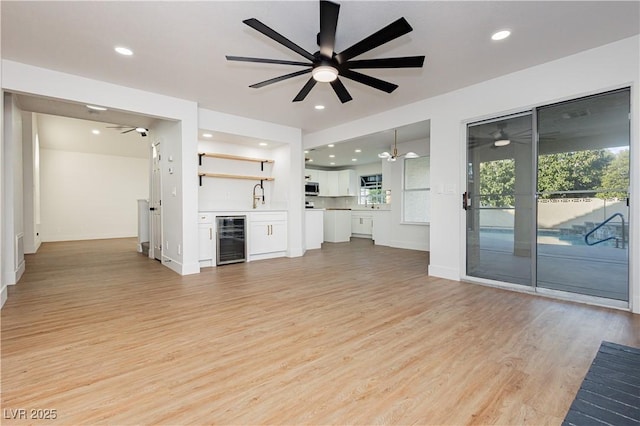 2107 Fountain Springs Dr, Henderson, NV 89074 - unfurnished living room featuring wine cooler, a ceiling fan, light wood-style floors, bar area, and recessed lighting