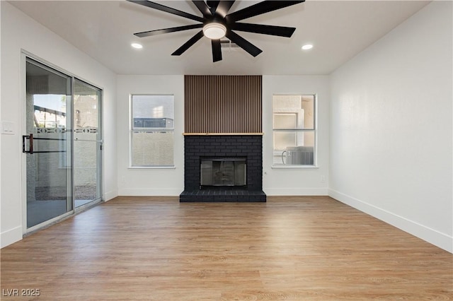 2107 Fountain Springs Dr, Henderson, NV 89074 - unfurnished living room featuring light wood-type flooring, a fireplace, a ceiling fan, and recessed lighting