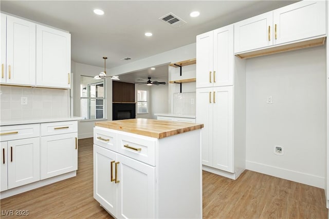 2107 Fountain Springs Dr, Henderson, NV 89074 - kitchen featuring wooden counters, a ceiling fan, light wood-style floors, open shelves, and backsplash