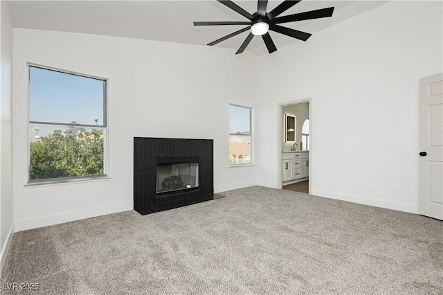 2107 Fountain Springs Dr, Henderson, NV 89074 - unfurnished living room with plenty of natural light, carpet floors, lofted ceiling, ceiling fan, and a fireplace