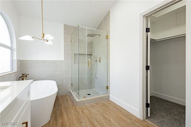 2107 Fountain Springs Dr, Henderson, NV 89074 - bathroom with a walk in closet, a stall shower, a soaking tub, a chandelier, and vanity