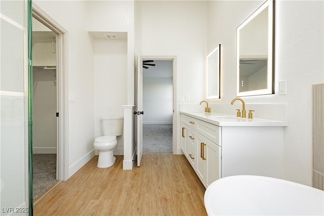 2107 Fountain Springs Dr, Henderson, NV 89074 - full bath featuring wood finished floors, double vanity, a ceiling fan, and a spacious closet