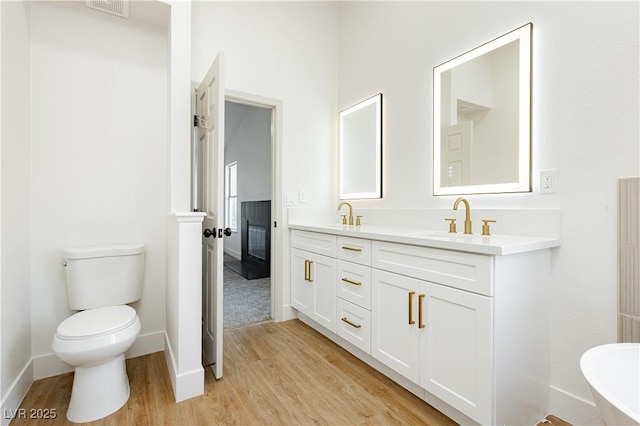 2107 Fountain Springs Dr, Henderson, NV 89074 - full bathroom featuring wood finished floors, double vanity, and a soaking tub