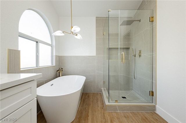 2107 Fountain Springs Dr, Henderson, NV 89074 - full bath featuring a stall shower, a freestanding bath, vanity, wood finished floors, and tile walls