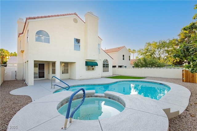 2107 Fountain Springs Dr, Henderson, NV 89074 - view of swimming pool featuring a patio, a fenced backyard, and a pool with connected hot tub