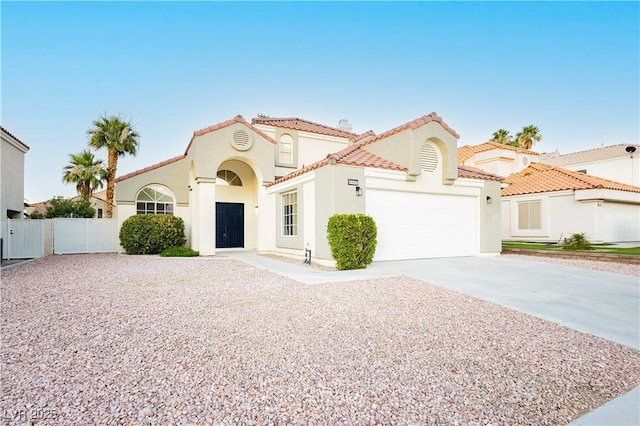 2107 Fountain Springs Dr, Henderson, NV 89074 - mediterranean / spanish-style home featuring stucco siding, concrete driveway, a garage, and a tiled roof