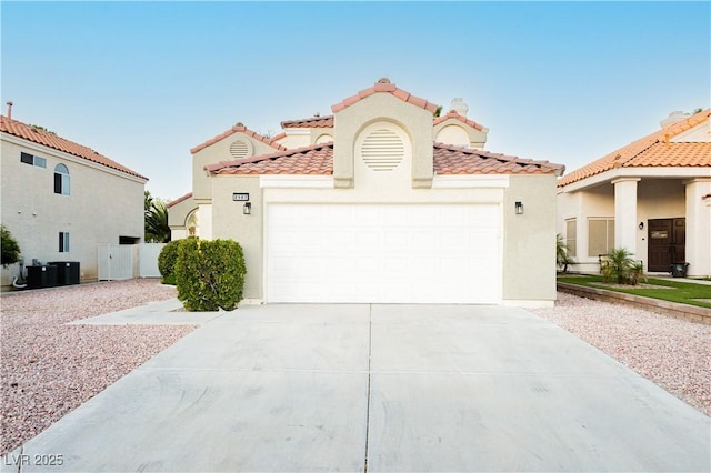 2107 Fountain Springs Dr, Henderson, NV 89074 - mediterranean / spanish-style house featuring concrete driveway, stucco siding, a tile roof, and a garage