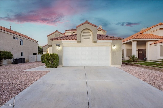 2107 Fountain Springs Dr, Henderson, NV 89074 - mediterranean / spanish home with concrete driveway, stucco siding, a garage, and a tile roof