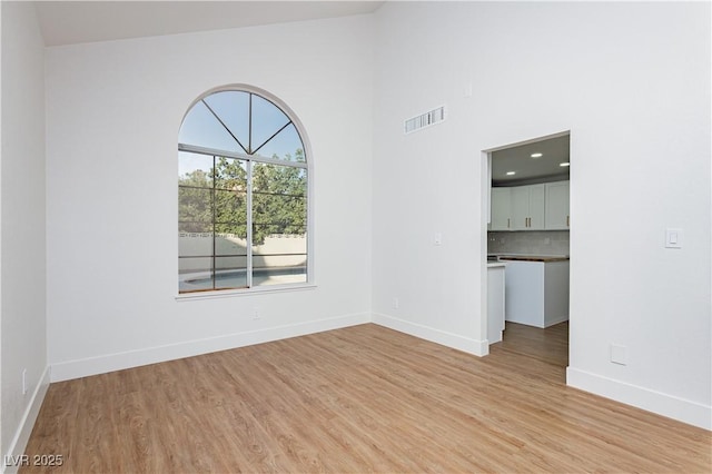 2107 Fountain Springs Dr, Henderson, NV 89074 - unfurnished room with light wood finished floors and high vaulted ceiling