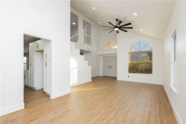 2107 Fountain Springs Dr, Henderson, NV 89074 - unfurnished living room featuring a ceiling fan, light wood-style flooring, healthy amount of natural light, recessed lighting, and high vaulted ceiling