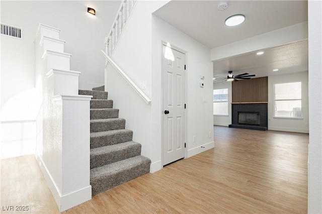 2107 Fountain Springs Dr, Henderson, NV 89074 - staircase with wood finished floors, ceiling fan, a fireplace, and recessed lighting