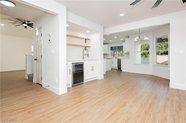 2107 Fountain Springs Dr, Henderson, NV 89074 - unfurnished living room featuring wine cooler, ceiling fan, light wood-style floors, wet bar, and recessed lighting