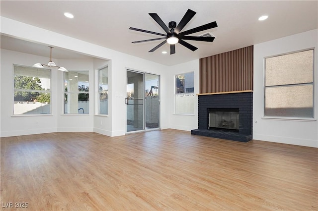 2107 Fountain Springs Dr, Henderson, NV 89074 - unfurnished living room with a fireplace, light wood finished floors, ceiling fan, and recessed lighting